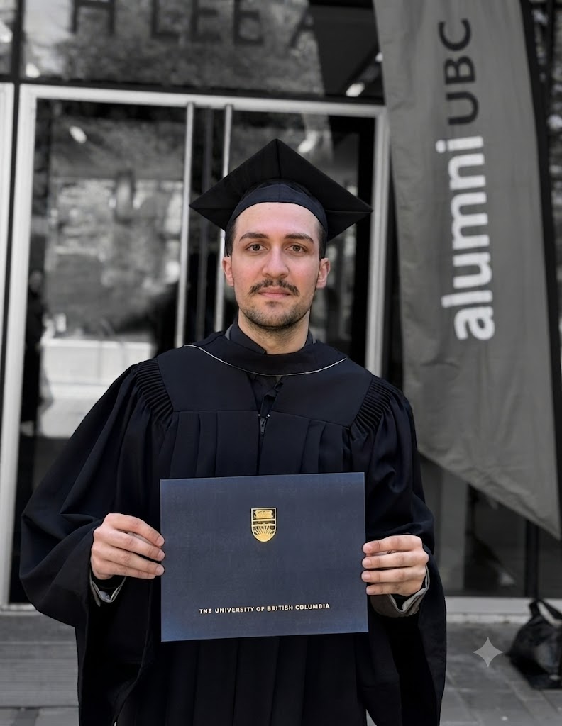 Pedram Asli in graduation attire holding his University of British Columbia diploma